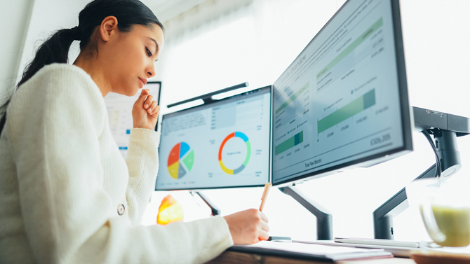 Woman with charts showing on computer